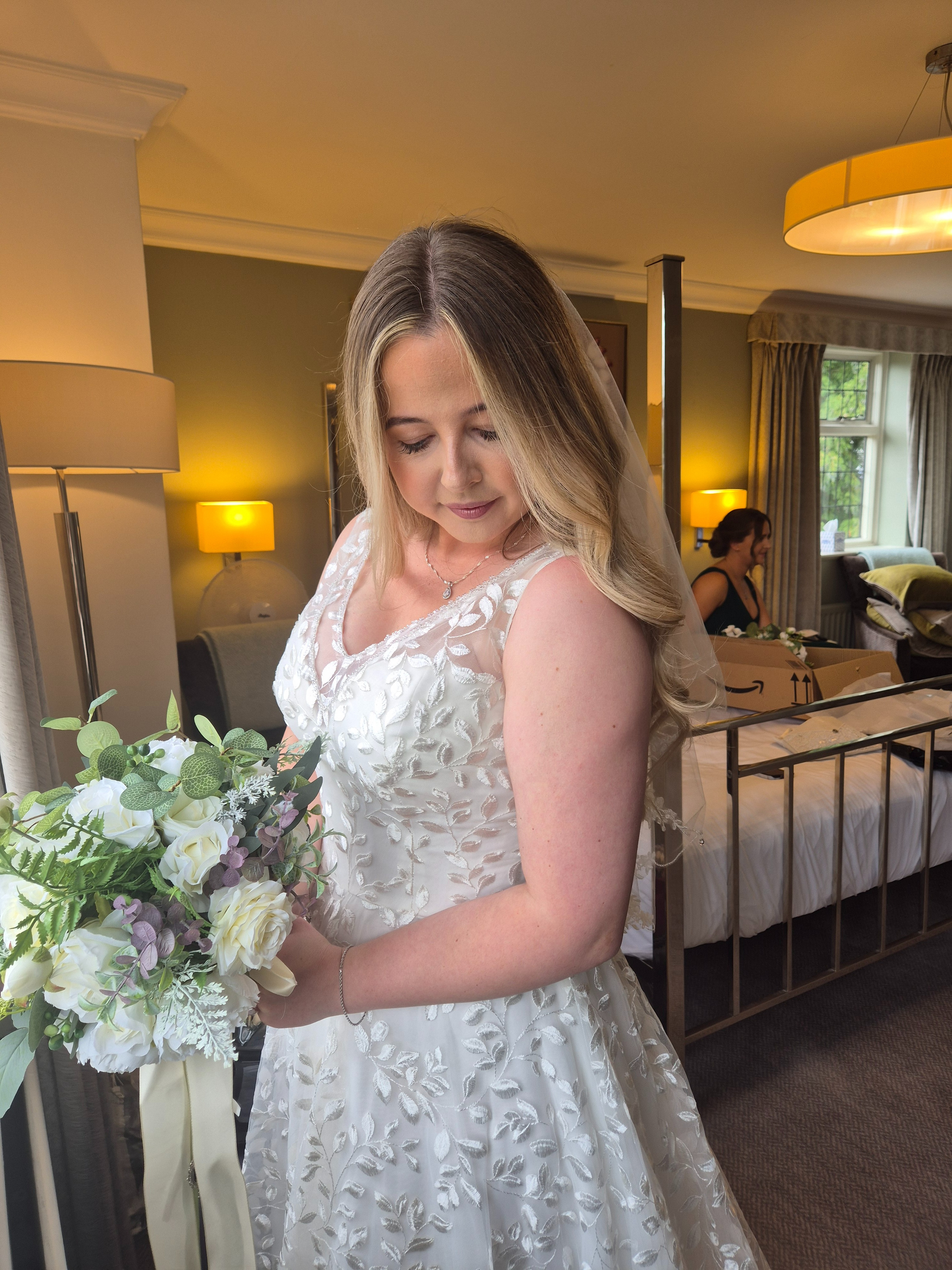 Bride holding bouquet with soft glam makeup