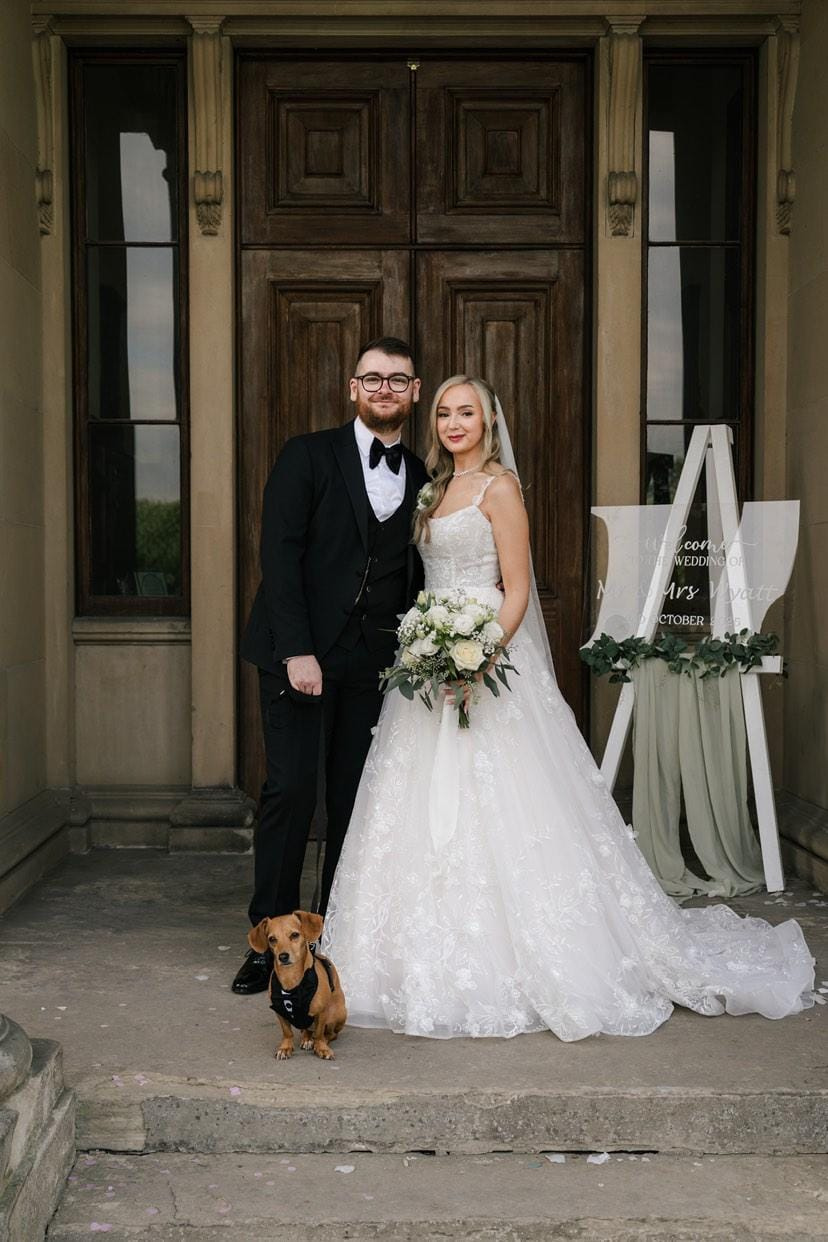 Bridal couple with dog at wedding